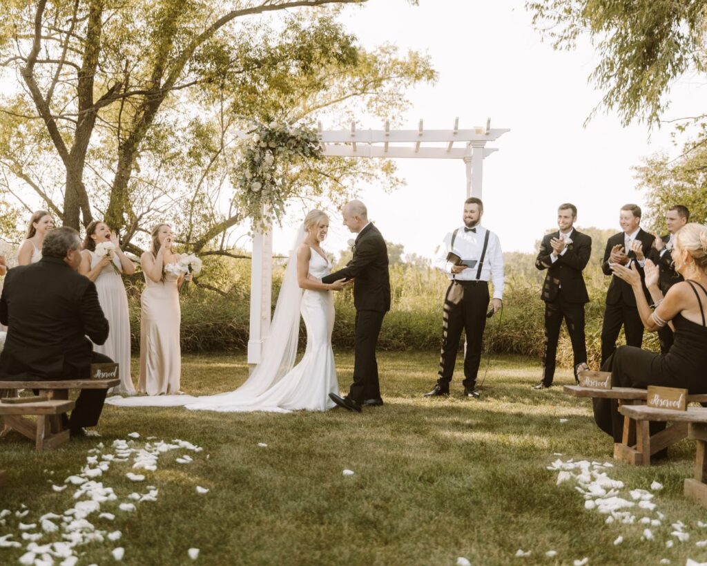 The bride and groom joyfully giggling at each other just moments after their first kiss as newlyweds.