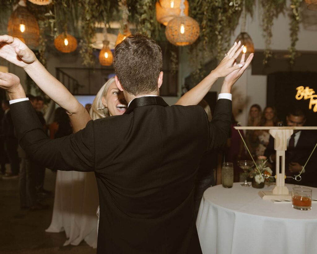 the bride and groom celebrating after the bride one the hook and ring game