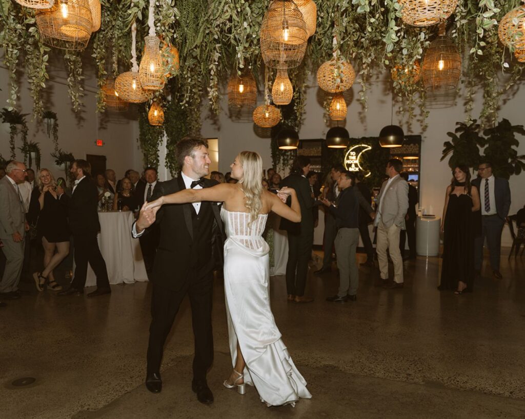 The bride and groom dancing their first dance in front of their guests