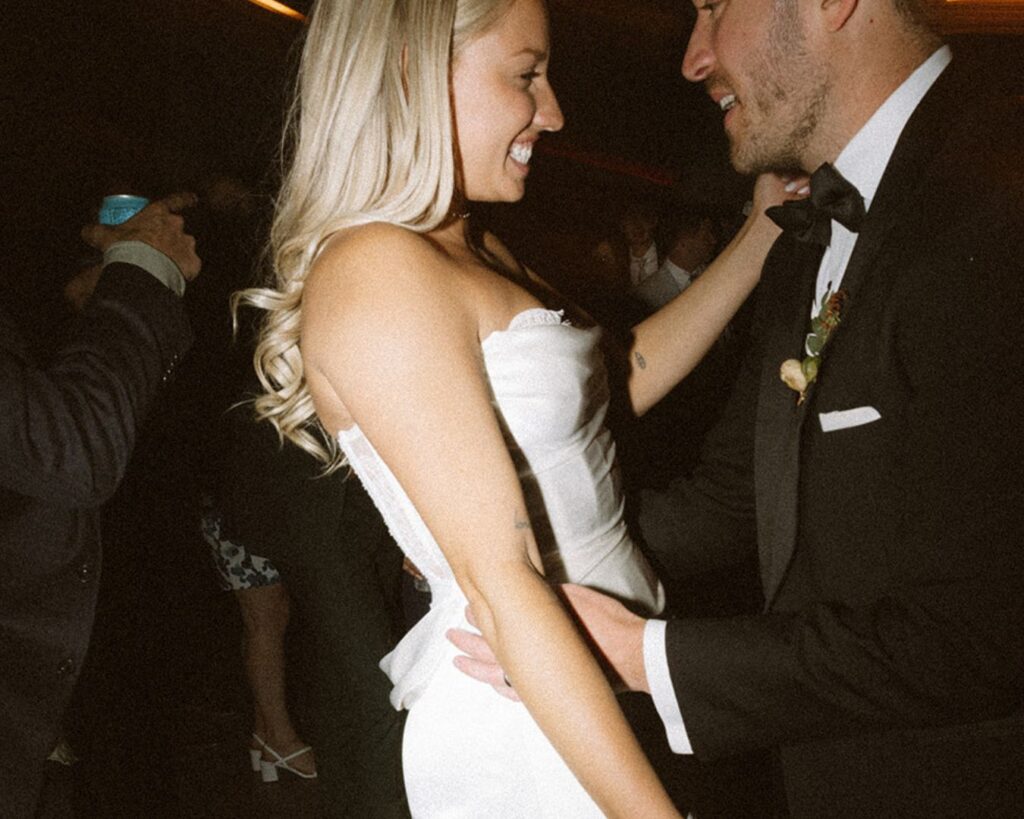 the bride and groom dancing together 